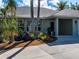 Landscaped home exterior featuring a garden with blue decorative vases at 721 Cadiz Rd, Venice, FL 34285