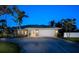 Charming single-story home boasts a well-manicured lawn, two-car garage, and lush tropical landscaping at 721 Cadiz Rd, Venice, FL 34285