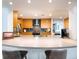 Bright kitchen featuring wood cabinets, stainless steel appliances, and a breakfast bar with seating at 721 Cadiz Rd, Venice, FL 34285