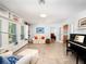 Well-lit living room featuring built-in shelving, tiled floor and comfortable seating at 721 Cadiz Rd, Venice, FL 34285