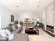 Large living room with tile floors, fireplace, and seamless open floor plan to kitchen and dining at 721 Cadiz Rd, Venice, FL 34285