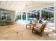 Inviting screened patio with comfortable seating, tile flooring, and backyard pool at 721 Cadiz Rd, Venice, FL 34285