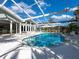 Sparkling pool within a screened enclosure and views of the home's exterior at 721 Cadiz Rd, Venice, FL 34285