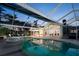 Sparkling pool surrounded by an enclosed lanai with tropical foliage and lots of lounging space at 721 Cadiz Rd, Venice, FL 34285