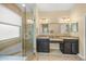 Elegant bathroom featuring a walk-in shower, dual sinks, and natural light from the window at 7911 Kavanagh Ct, Sarasota, FL 34240