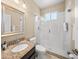 Bathroom featuring granite vanity top, tile floors and modern glass shower at 7911 Kavanagh Ct, Sarasota, FL 34240