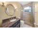 Bathroom with a large decorative mirror and a glass-enclosed shower with stone tile at 7911 Kavanagh Ct, Sarasota, FL 34240