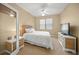 Cozy bedroom featuring a wicker bed frame, ceiling fan and neutral carpet flooring at 7911 Kavanagh Ct, Sarasota, FL 34240