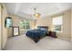 Comfortable bedroom with tray ceilings, carpet flooring, and natural light from two windows at 7911 Kavanagh Ct, Sarasota, FL 34240