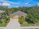 A beautiful single-Gathering home with a three-car garage surrounded by lush trees and landscaping at 7911 Kavanagh Ct, Sarasota, FL 34240