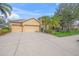 Charming single-story home featuring a two-car garage and lush tropical landscaping at 7911 Kavanagh Ct, Sarasota, FL 34240