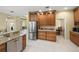 Stylish kitchen featuring stainless steel refrigerator, built-in cabinets, and a breakfast bar at 7911 Kavanagh Ct, Sarasota, FL 34240
