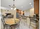 Open kitchen and dining area with tile floors, stainless steel appliances, and adjacent living space at 7911 Kavanagh Ct, Sarasota, FL 34240