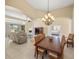 Spacious open-concept living area with tile floors, decorative columns and abundant natural light at 7911 Kavanagh Ct, Sarasota, FL 34240