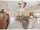 Expansive living area with elegant columns, tile flooring, and views of the dining and kitchen areas at 7911 Kavanagh Ct, Sarasota, FL 34240