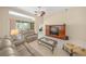 Bright living room featuring high ceilings, a ceiling fan, and a large entertainment center at 7911 Kavanagh Ct, Sarasota, FL 34240