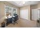 Home office featuring a desk, carpet, window and closet at 7911 Kavanagh Ct, Sarasota, FL 34240