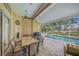 Covered patio with dining area looking out to a screened-in pool at 7911 Kavanagh Ct, Sarasota, FL 34240
