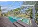A screened-in swimming pool and hot tub with brick pavers offers a relaxing outdoor retreat at 7911 Kavanagh Ct, Sarasota, FL 34240
