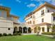 Classic building with arches, balconies, and a lush lawn, showcasing elegant design elements at 8472 Bay Breeze Ln, Sarasota, FL 34243