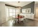 Dining area featuring bay windows, modern lighting, and stylish decor at 9716 28Th E St, Parrish, FL 34219