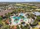 Lush aerial image showcasing a resort-style pool area, palm trees, and well-maintained landscaping at 13908 Messina Loop, Bradenton, FL 34211