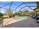 Screened-in pool and patio area, surrounded by lush landscaping at 13908 Messina Loop, Bradenton, FL 34211