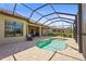 Inviting pool and patio area with views of neighboring house, encased in an enclosure for comfortable outdoor enjoyment at 13908 Messina Loop, Bradenton, FL 34211