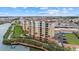 Picturesque aerial view of the building complex, lush green spaces, waterway, and surrounding cityscape at 147 Tampa E Ave # 702, Venice, FL 34285