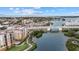 Stunning aerial view of the waterfront community, bridge, and pool at 147 Tampa E Ave # 702, Venice, FL 34285