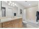 Bathroom with wood vanity, shower-tub combo, and nautical decorations at 147 Tampa E Ave # 702, Venice, FL 34285
