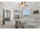 Comfortable bedroom with balcony access, ceiling fan and a large window with shutters at 147 Tampa E Ave # 702, Venice, FL 34285