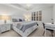 Bedroom features neutral colors, modern furnishings, and a large window with shutters at 147 Tampa E Ave # 702, Venice, FL 34285