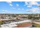 Breathtaking city view with palm trees, blue skies, and fluffy white clouds over commercial buildings at 147 Tampa E Ave # 702, Venice, FL 34285