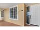 Condo entrance featuring a white front door, ample natural light and a building number plaque at 147 Tampa E Ave # 702, Venice, FL 34285