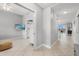 Bright hallway featuring tile flooring, neutral paint, and an open doorway leading to other rooms at 147 Tampa E Ave # 702, Venice, FL 34285