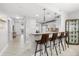 Open kitchen design with bar seating and a partial view of the living area at 147 Tampa E Ave # 702, Venice, FL 34285