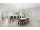 Open concept living room featuring a dining area, breakfast bar, and an elegant chandelier at 147 Tampa E Ave # 702, Venice, FL 34285
