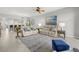 Open-concept living room features stylish furniture, decor, ceiling fan and a view into the dining area at 147 Tampa E Ave # 702, Venice, FL 34285