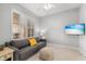 Cozy living room featuring plantation shutters, tile flooring, and a comfortable sofa at 147 Tampa E Ave # 702, Venice, FL 34285