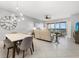 Open concept living room with a dining area and balcony access with beautiful views at 147 Tampa E Ave # 702, Venice, FL 34285
