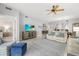 Bright living room featuring stylish furniture, decor, ceiling fan and a view into the dining area at 147 Tampa E Ave # 702, Venice, FL 34285