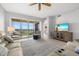 Bright living room featuring balcony access with views, comfortable seating, and a ceiling fan at 147 Tampa E Ave # 702, Venice, FL 34285