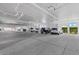 Spacious parking garage with ample parking spots for SUVs and sedans, with bright, neutral-toned walls at 147 Tampa E Ave # 702, Venice, FL 34285