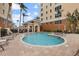 Outdoor pool area surrounded by lounge chairs and palm trees at 147 Tampa E Ave # 702, Venice, FL 34285