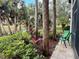 Relaxing backyard view of plants, trees, and pond area from a back patio with chair at 1515 Forrest Nelson Blvd # P107, Port Charlotte, FL 33952