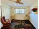 Cozy bedroom with ceiling fan, rocking chair, area rug, and closet space at 1515 Forrest Nelson Blvd # P107, Port Charlotte, FL 33952