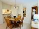 Dining room with wood table and seating for four, chandelier, and views to kitchen at 1515 Forrest Nelson Blvd # P107, Port Charlotte, FL 33952