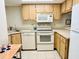 Efficient kitchen with white appliances and ample cabinet space at 1515 Forrest Nelson Blvd # P107, Port Charlotte, FL 33952