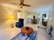 Comfortable living room with natural lighting, ceiling fan, and views to the dining area at 1515 Forrest Nelson Blvd # P107, Port Charlotte, FL 33952